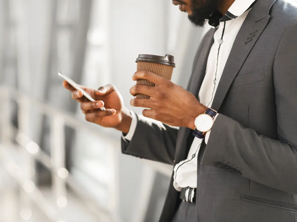 Developer programmatic at a computer, with a text message being delivered to a cell phone, and an Indian flag in the background